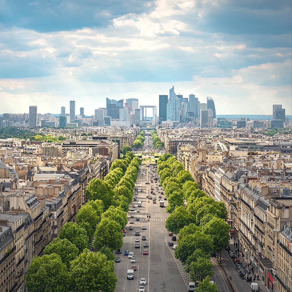 Man standing on a luxurious balcony, holding a tablet